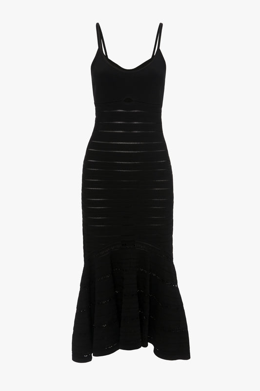 A black sleeveless body-sculpting dress with a fitted bodice, thin straps, and a flared, ruffled hem. The Cut-Out Detail Cami Dress In Black by Victoria Beckham.