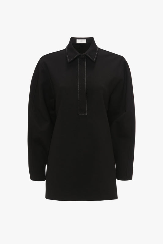 A long-sleeved black Waistcoat Detail Ponti Top In Black with a collar and a vertical seam detail on the front, showcasing a distinctive personality with its contemporary twist, displayed on a white background by Victoria Beckham.