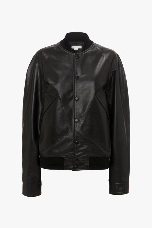 A Leather Varsity Jacket In Black by Victoria Beckham with a front snap-button closure and ribbed cuffs.