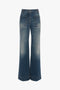 Front view of a pair of Alina High Waisted Jean In Heavy Vintage Indigo Wash by Victoria Beckham with large front pockets and slightly faded detailing on the thighs, exuding a retro appeal reminiscent of Victoria Beckham's tailored designs.