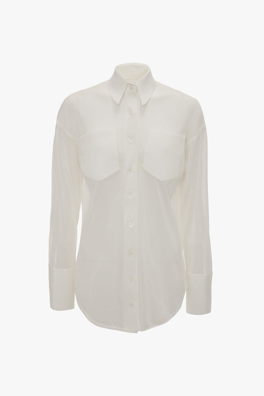 A Victoria Beckham Pocket Detail Shirt In White with a relaxed fit, featuring front patch pockets, a collar, and cuffs.
