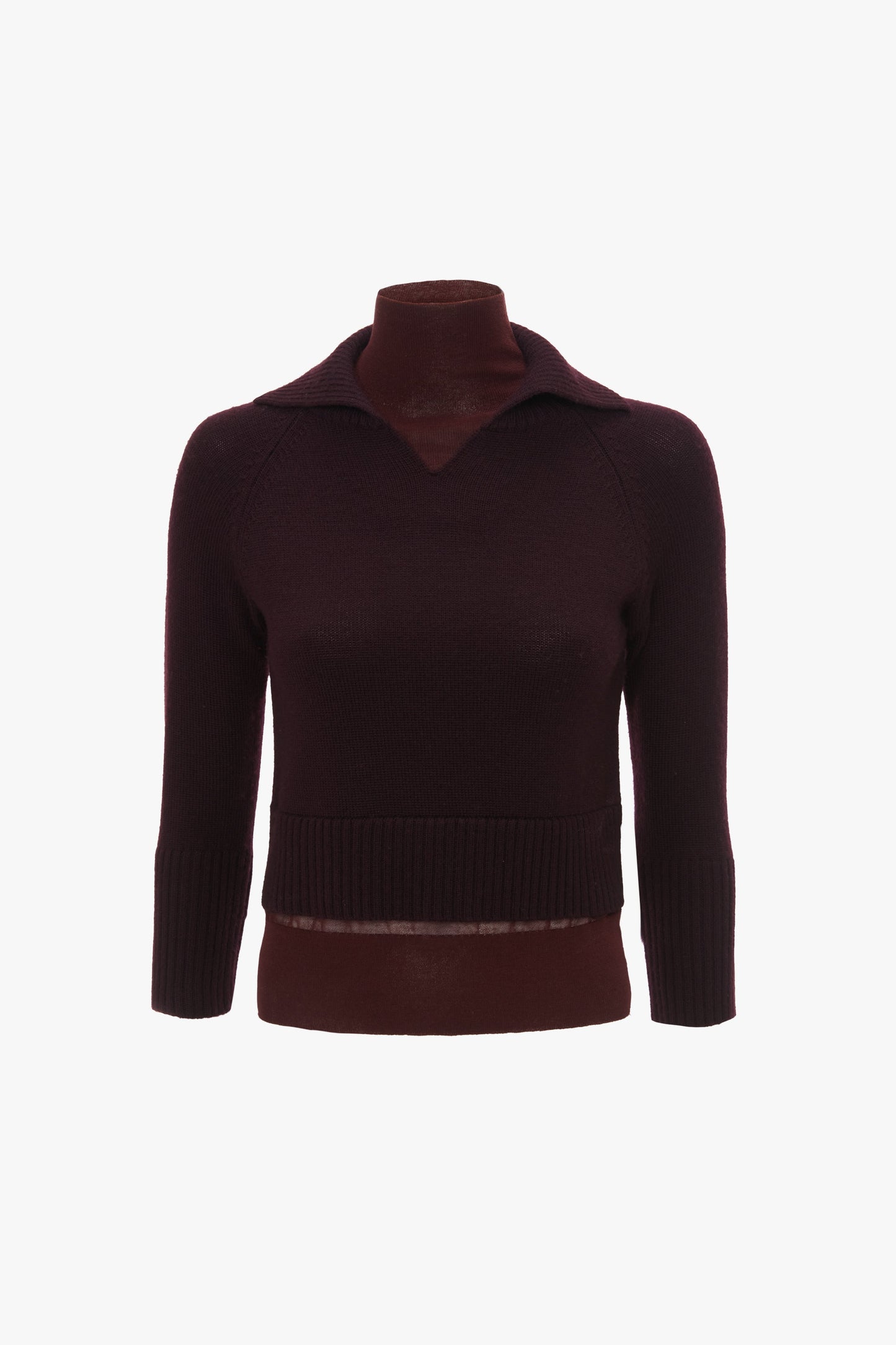 A dark burgundy, long-sleeve, V-neck sweater made of merino wool knit is displayed on a mannequin with a plain white background. The fitted silhouette features ribbed cuffs and hem, exemplifying timeless elegance. This is the Double Layer Top in Deep Mahogany by Victoria Beckham.