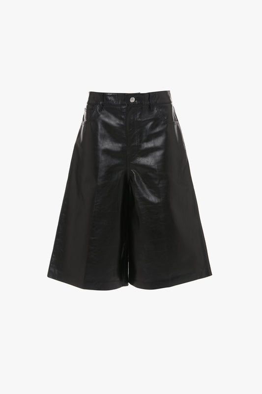 A pair of Leather Bermuda Short In Black by Victoria Beckham, knee-length with wide-leg design, displayed against a white background.