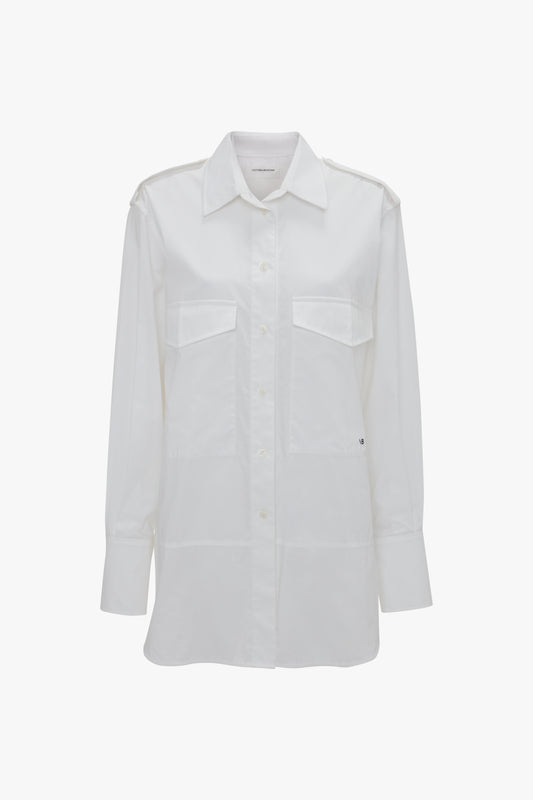 A long-sleeved white button-up Oversized Pocket Shirt In White by Victoria Beckham with two front chest pockets, crafted from organic cotton and displayed against a white background, exudes modern sophistication.