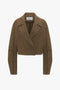 A brown, cropped peacoat crafted from merino wool with long sleeves, a wide lapel collar, and a double-breasted design featuring two front pockets has been replaced with the Victoria Beckham Cropped Pea Coat In Khaki.