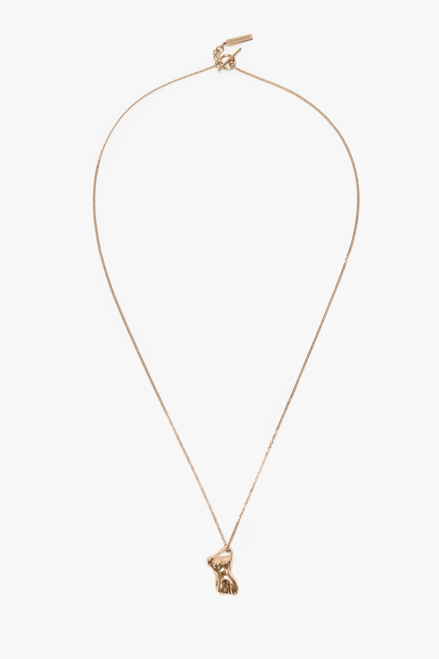 A Victoria Beckham Exclusive Body Charm Necklace In Light Gold featuring a small, detailed bunny pendant on a fine chain, crafted from 100% brass.