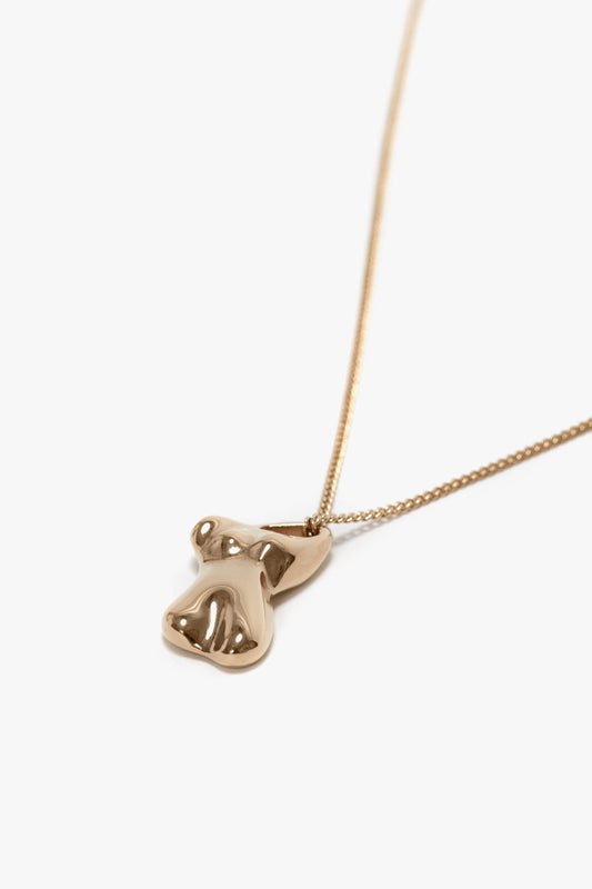 An Exclusive Body Charm Necklace In Light Gold by Victoria Beckham crafted from 100% brass, featuring a pendant in an abstract form with a light gold finish.