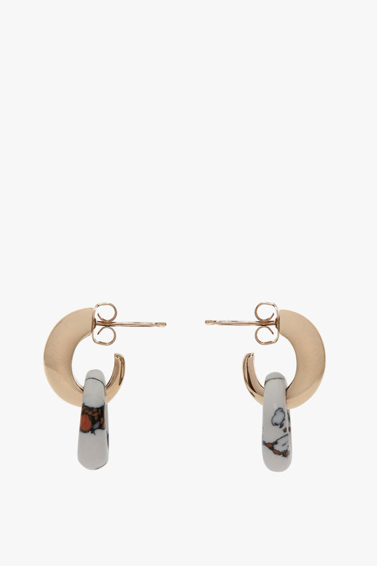 Light Gold/White earrings with marbled hoops, crafted in Italy and featuring an antiallergic stainless-steel closure have been replaced by Victoria Beckham's Exclusive Resin Pendant Earrings In Light Gold-White.