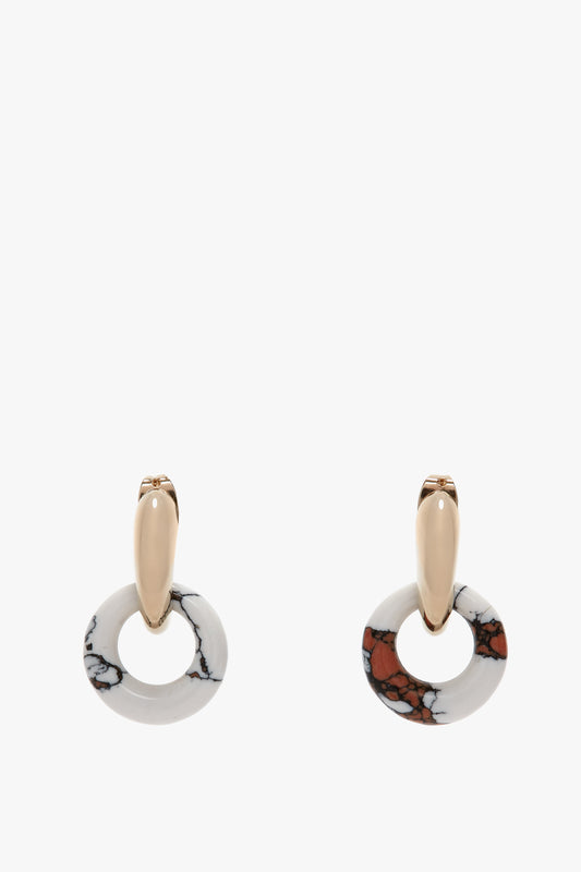 Exclusive Resin Pendant Earrings In Light Gold-White by Victoria Beckham featuring gold-tone studs and circular pendants with white and brown marbled patterns, crafted in Italy. Enhanced with an antiallergic stainless-steel closure for comfort.