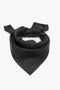 A Victoria Beckham Leather Scarf In Black, crafted from supple leather, folded into a triangular shape with a classic knot at the top.