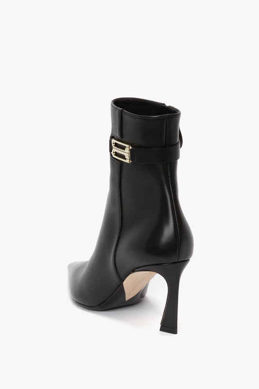 Pointed Toe Half Boot In Black Soft Calf Leather by Victoria Beckham with a pointed toe and gold buckle on the side, boasting a refined silhouette in a sleek and elegant style.