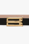 Close-up of a Victoria Beckham Exclusive Micro Frame Belt In Black Leather with a gold hardware buckle against a white background.