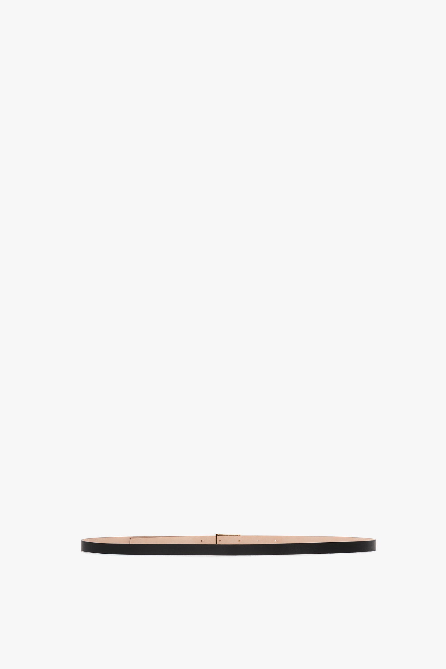 A minimalist image of an Exclusive Victoria Beckham Micro Frame Belt in Black Leather with small gold hardware, centered against a plain white background.