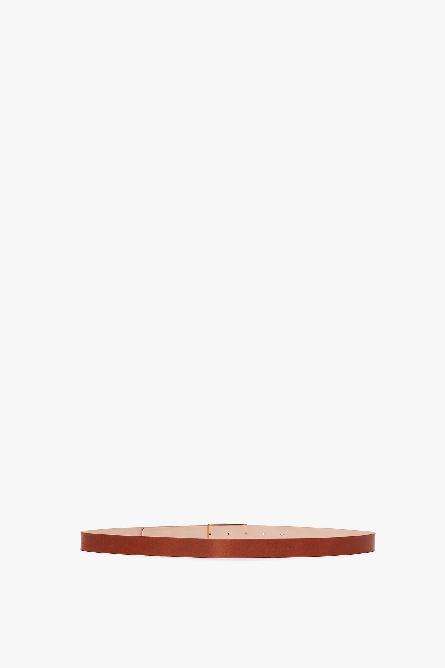 Exclusive Frame Buckle Belt In Tan Leather by Victoria Beckham, isolated on a white background.