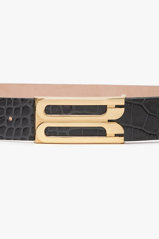 A Jumbo Frame Belt In Slate Grey Croc Embossed Calf Leather from Victoria Beckham, featuring a gold-colored buckle and crafted from croc-embossed calf leather.