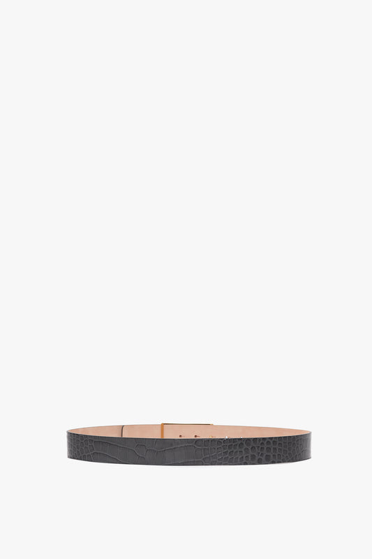 A Victoria Beckham Jumbo Frame Belt In Slate Grey Croc Embossed Calf Leather laid flat against a neutral background.
