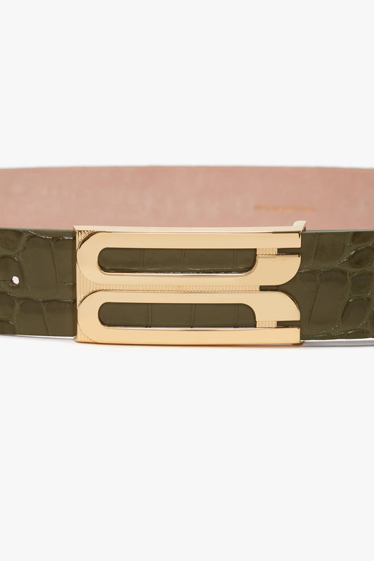 A close-up of an Exclusive Jumbo Frame Belt In Khaki Croc Embossed Calf Leather by Victoria Beckham, highlighting its green texture and elegant Jumbo Frame Belt design.