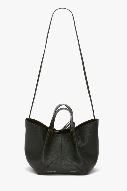 A W11 Mini Tote Bag In Loden Leather by Victoria Beckham with a long strap and short handles, perfect for crossbody wear.