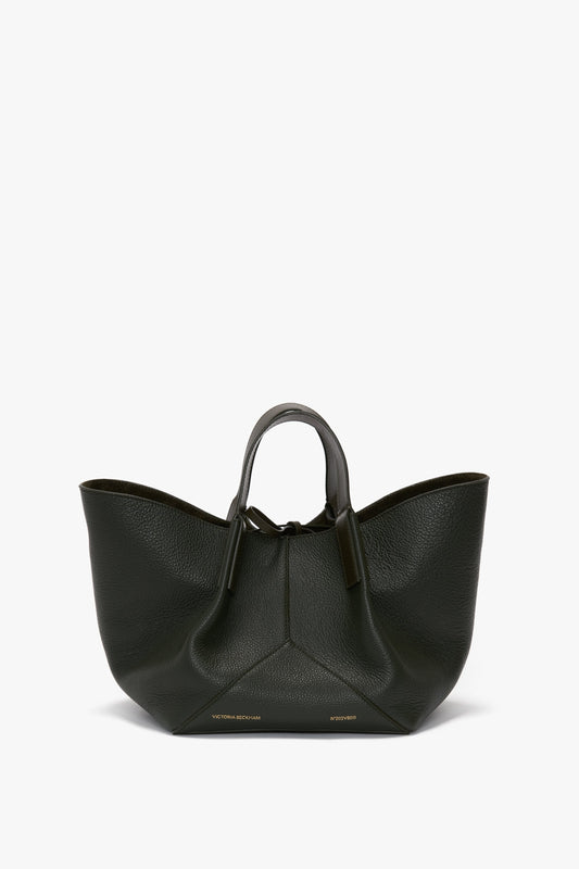 A black, textured calf leather W11 Mini Tote Bag In Loden Leather with a uniquely curved shape and two short handles from Victoria Beckham.
