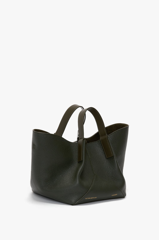 A dark green W11 Mini Tote Bag In Loden Leather crafted from calf leather, featuring two handles and a structured, minimalist design by Victoria Beckham.