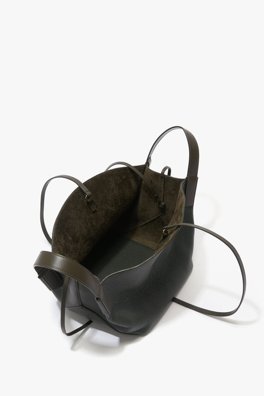 A loden leather W11 Mini Tote Bag by Victoria Beckham with long straps and an open top, showcasing its spacious interior lined in dark suede.