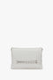 Chain Pouch Bag with Brushed Silver Chain In White by Victoria Beckham with a rectangular shape and a decorative chain link accent on the front. Features silver VB branding and a detachable strap for versatile wear.