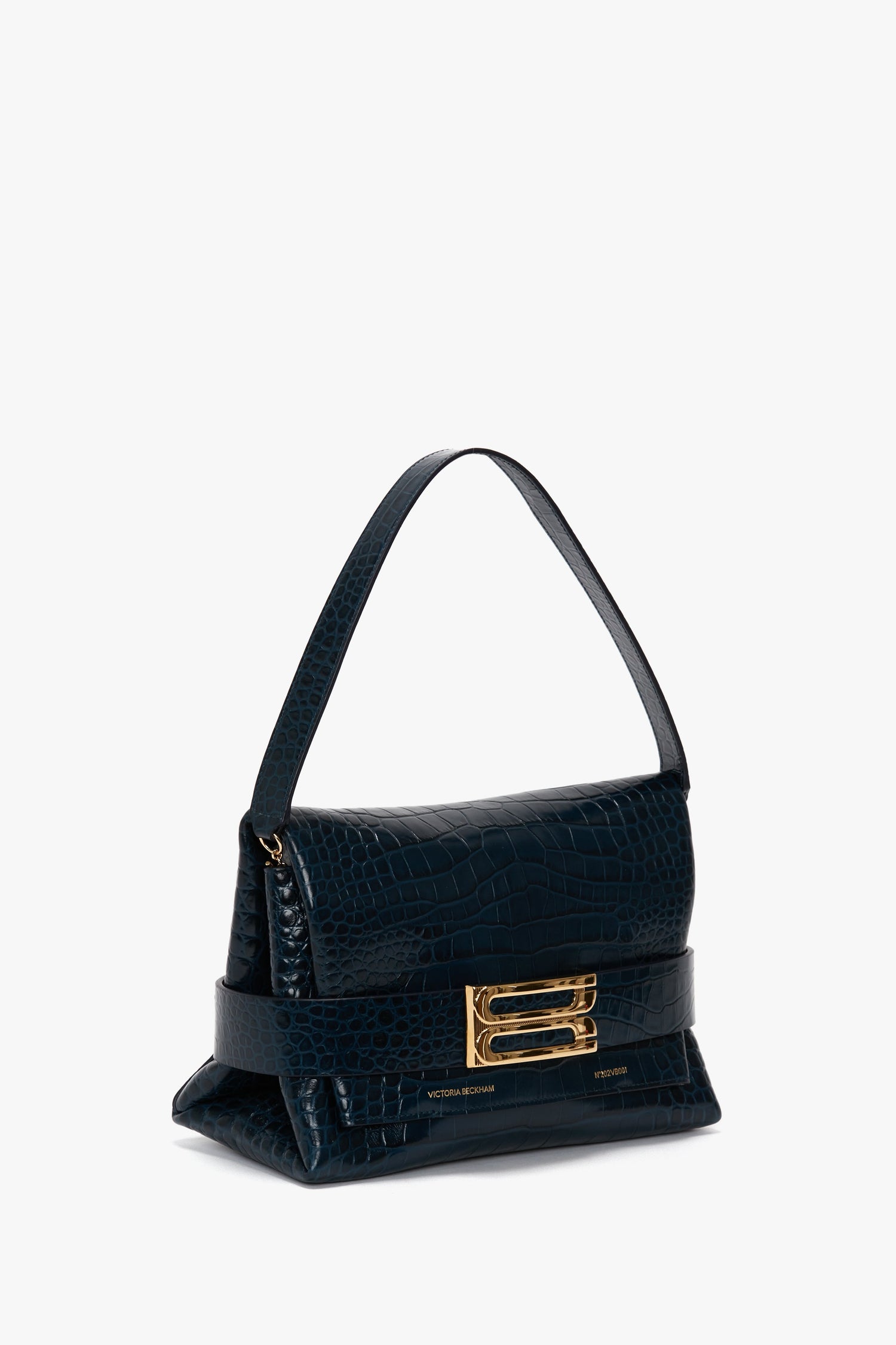 A B Pouch Bag In Croc Effect Midnight Blue Leather by Victoria Beckham, crafted from calf leather, featuring a single strap and a gold clasp closure.