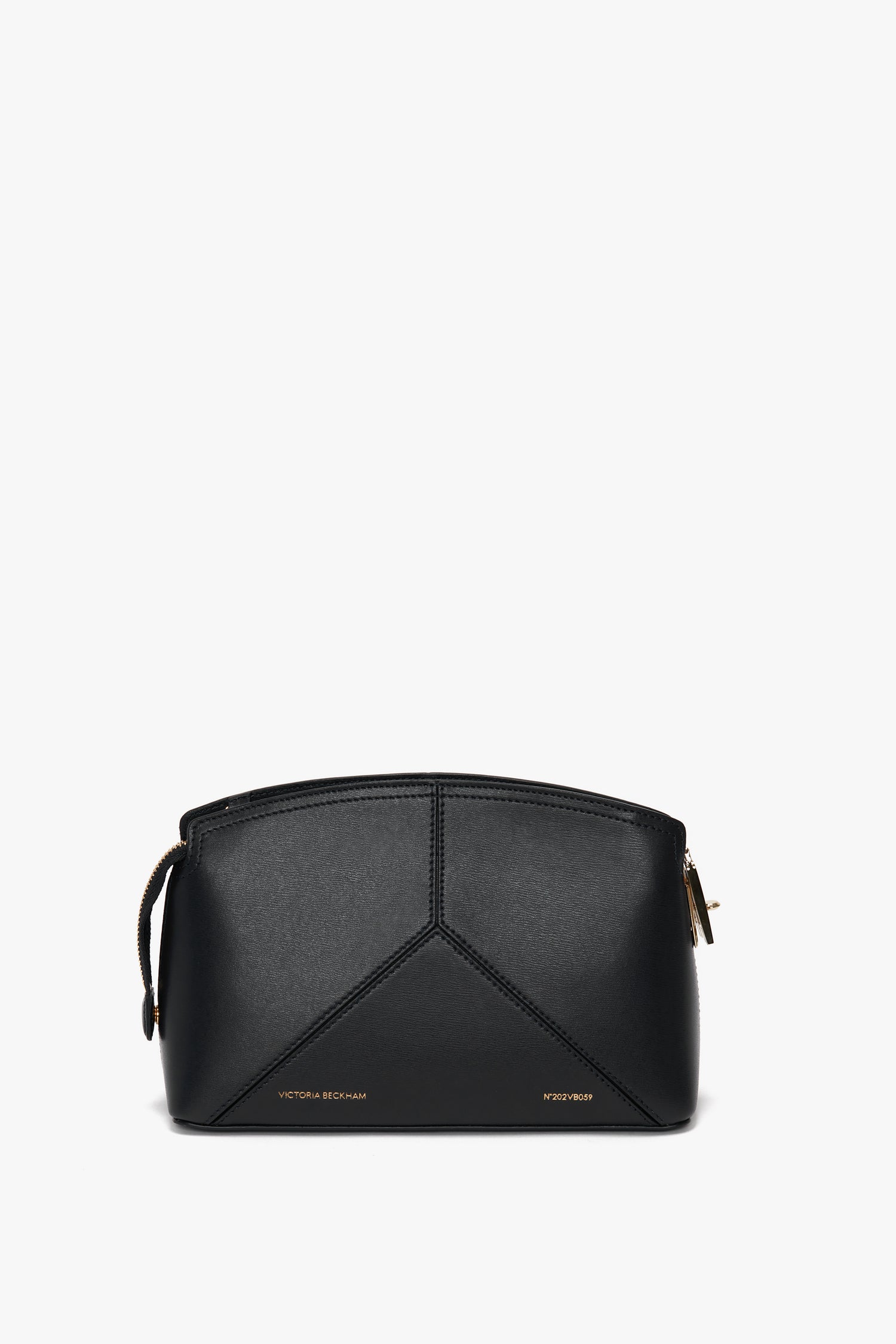 A Victoria Crossbody Bag In Black Leather, crafted from textured calf leather with geometric stitching details, a gold zipper, and an adjustable strap. Embossed text reads "Victoria Beckham" and "Penny" at the bottom.