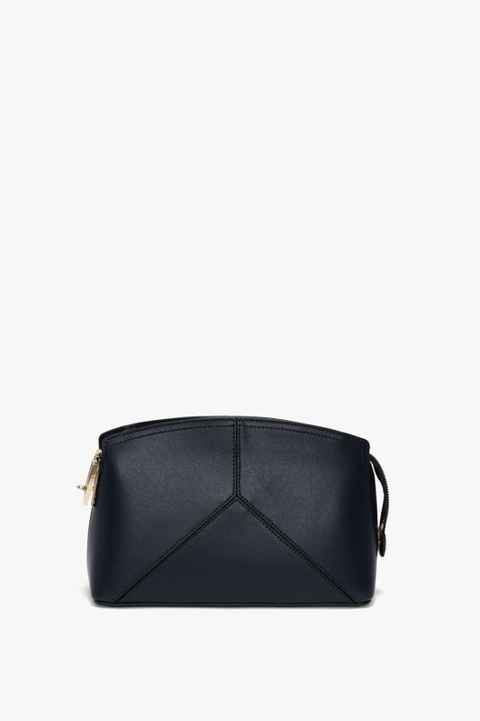 A black leather handbag with leather panels and a triangular stitched pattern on the front, featuring a zippered closure. The **Exclusive Victoria Crossbody Bag In Navy Leather** by **Victoria Beckham** stands out with its exquisite design and premium craftsmanship.