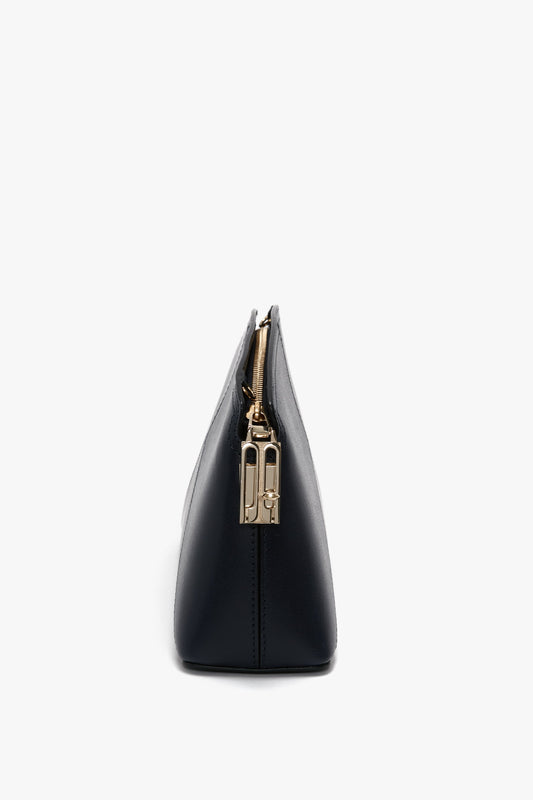 Side view of an Exclusive Victoria Crossbody Bag In Navy Leather by Victoria Beckham against a white background.
