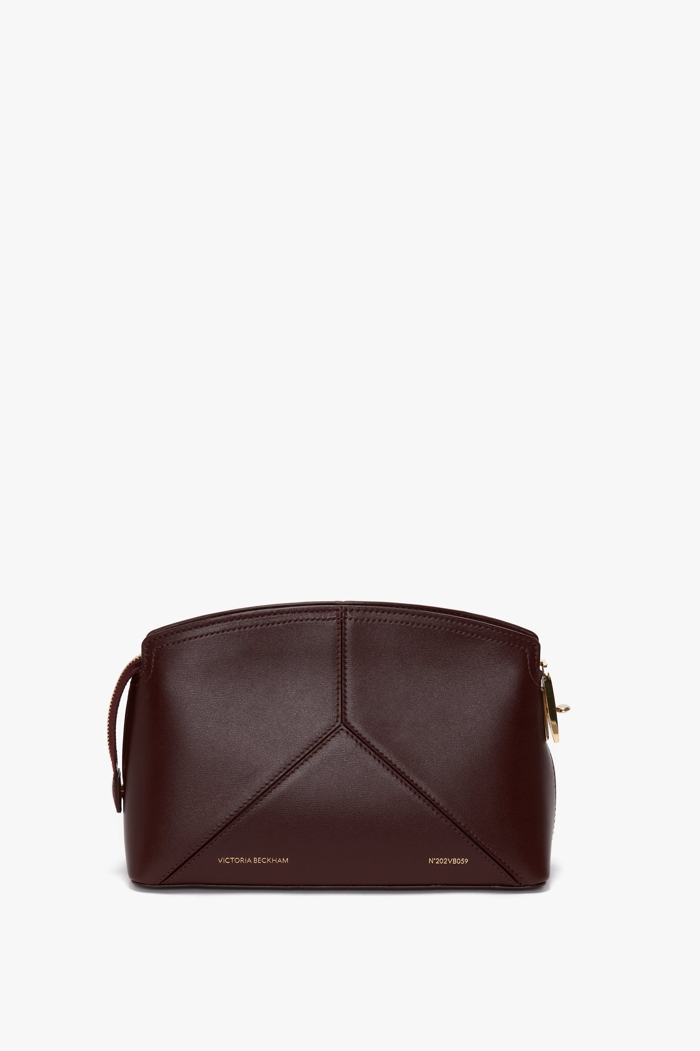 A Victoria Crossbody Bag In Burgundy Leather with a geometric stitch pattern, gold zipper closure, and "Victoria Beckham" branding.
