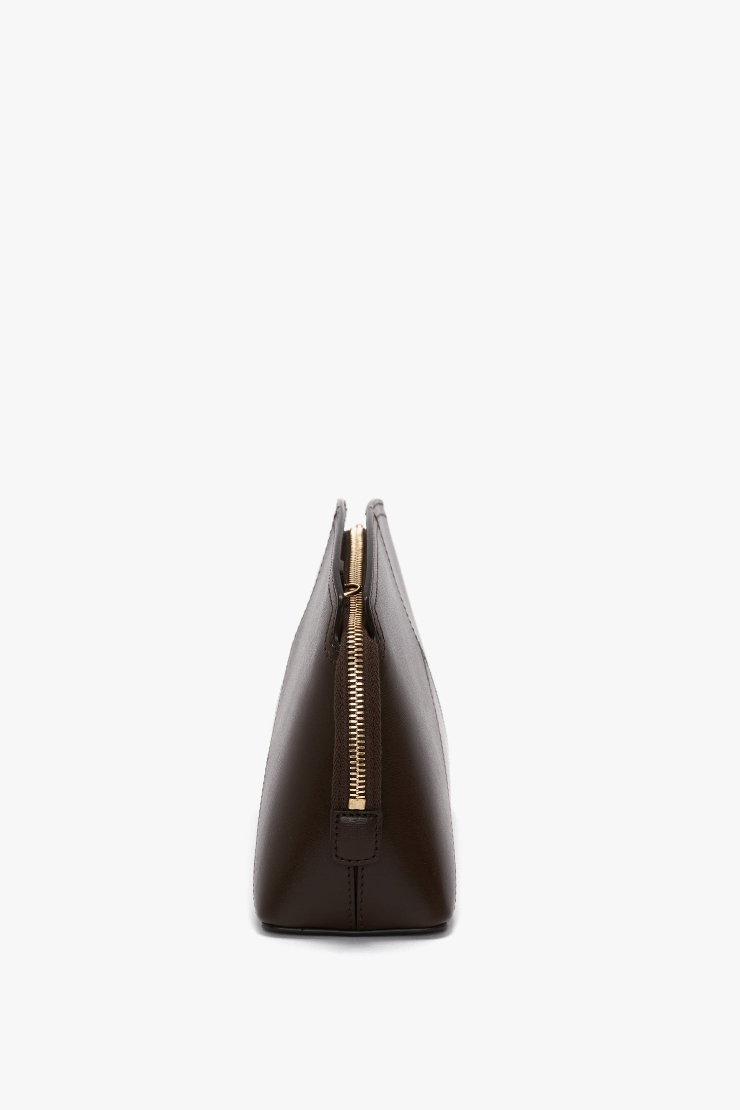 Side view of a dark brown calf leather Exclusive Victoria Crossbody Bag In Brown Leather by Victoria Beckham standing upright against a plain white background.