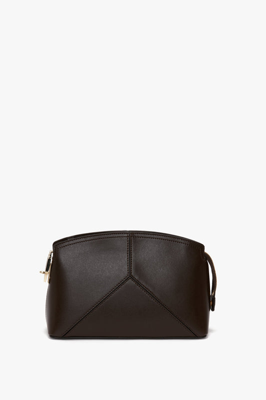 A small, dark brown calf leather pouch with geometric stitching and a zip closure on the left side, perfect for pairing with the Exclusive Victoria Crossbody Bag In Brown Leather by Victoria Beckham.