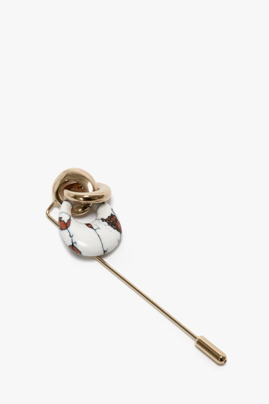 Exclusive Resin Charm Brooch In Light Gold-White by Victoria Beckham, with marbled white, black, and red stone detailing the handle, featuring a light gold/white design made in Italy.