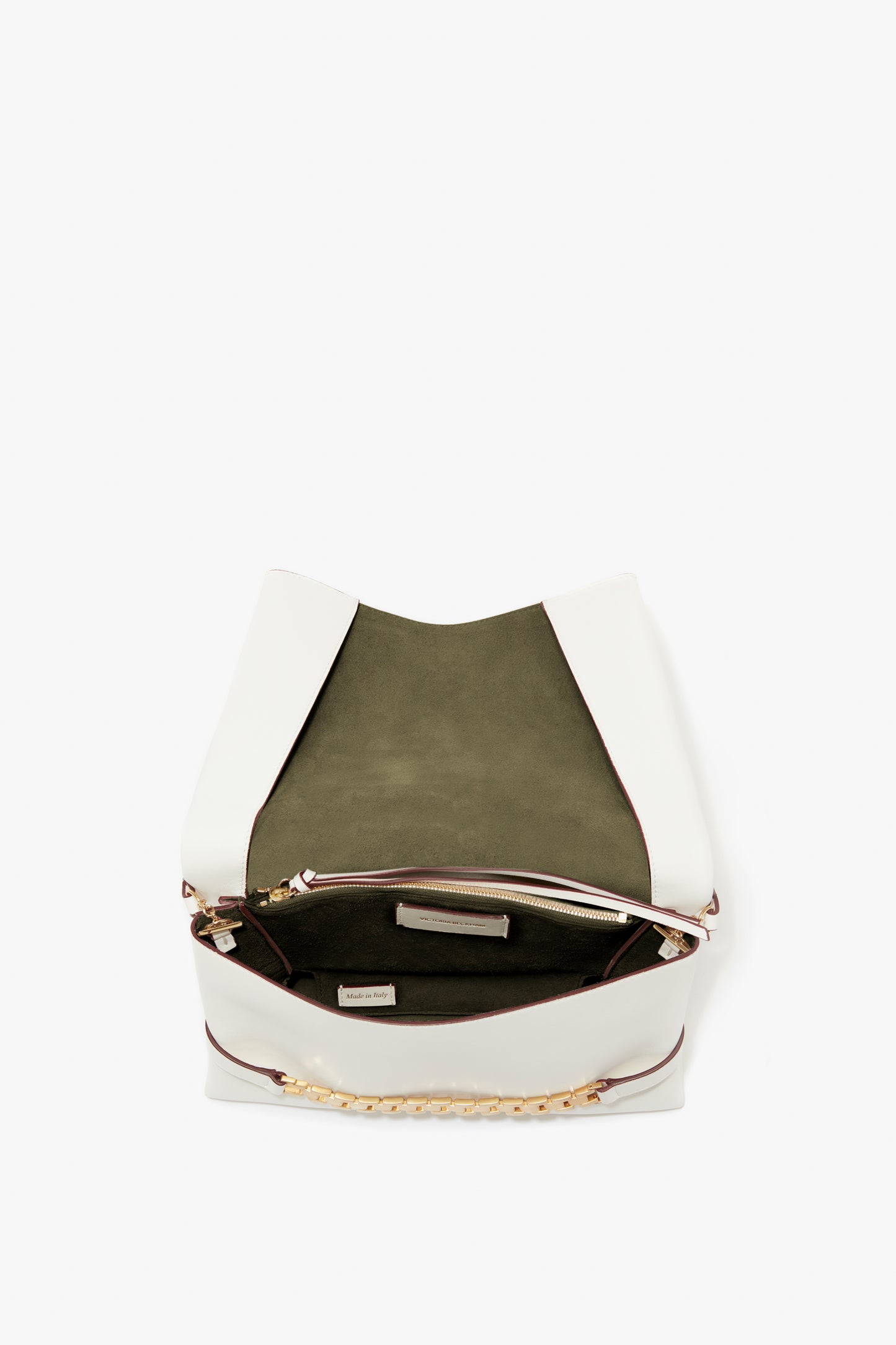 Chain Pouch with Strap In White Leather designer handbag by Victoria Beckham, featuring a front flap open, green interior, and small interior pocket.
