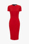 A Victoria Beckham red knee-length fitted T-shirt dress with short sleeves and a round neckline, displayed on a plain white background.