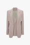 Victoria Beckham Double Panel Front Jacket In Rose Quartz with notched lapels, padded shoulders, a single chest pocket, and two front flap pockets. This classic tailored jacket is displayed on a white background.