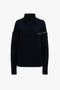 Collar Detail Jumper In Navy by Victoria Beckham with ribbed texture and cut-out shoulder design, displayed against a white background. This chic lambswool jumper combines contemporary style with cozy warmth.