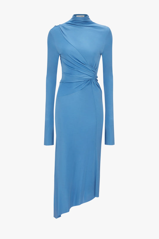 A High Neck Asymmetric Draped Dress In Oxford Blue by Victoria Beckham, with a twist design at the waist and midi-length, is displayed against a white background.