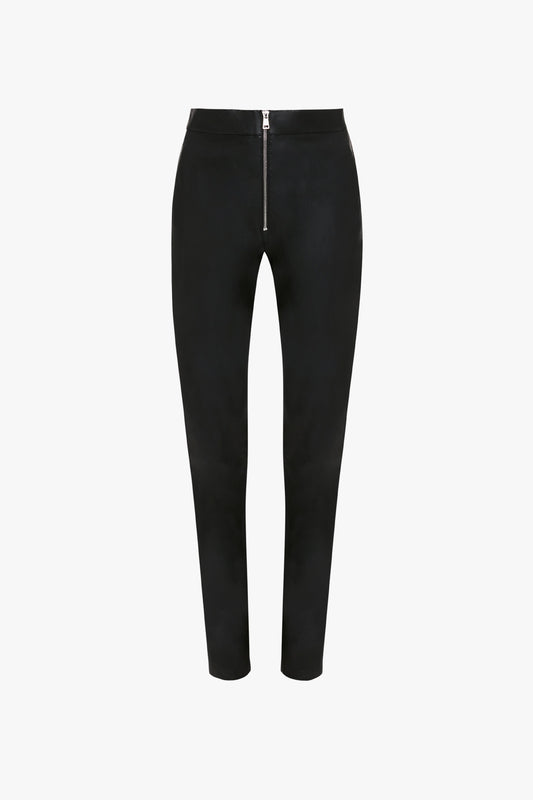 Victoria Beckham Slim Leather Trouser in Black with a front zipper and no visible pockets, offering a sleek alternative to denim, set against a plain white background.