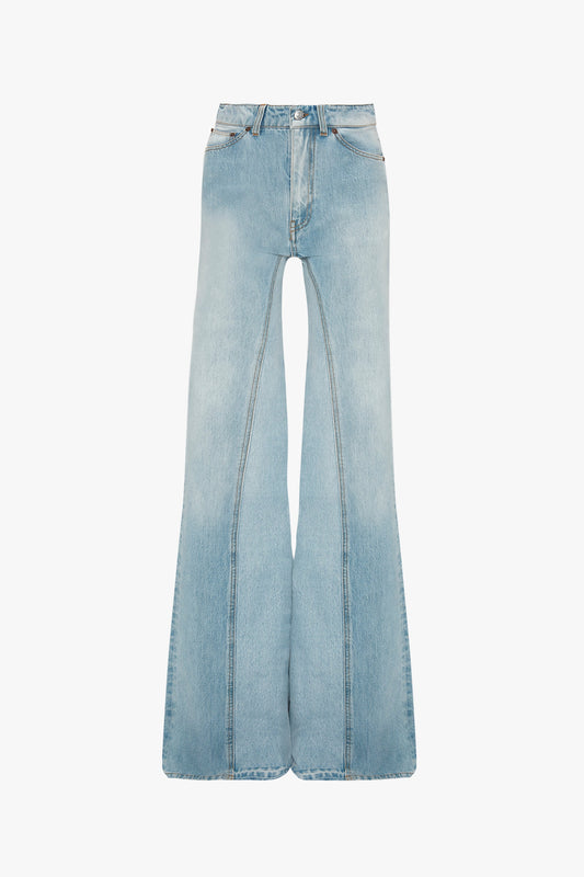 Sentence with the replaced product: Victoria Beckham's Bianca Jean In Light Blue Denim, high-waisted flare jeans isolated on a white background.