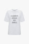 A relaxed fit, organic cotton white T-shirt featuring the slogan "Fashion Stole My Smile" printed in bold black text on the front, the **Fashion Stole My Smile Slogan T-Shirt In White** by **Victoria Beckham**.