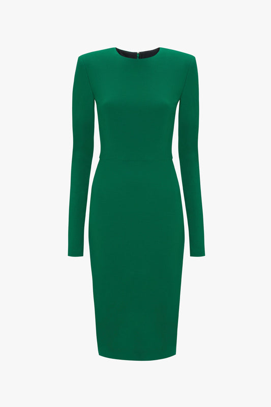 A green, long-sleeved, knee-length dress with a fitted silhouette and a small button closure at the back of the neck. Crafted from bi-stretch crepe fabric, this Long Sleeve T-Shirt Fitted Dress in Emerald by Victoria Beckham offers comfort and style.