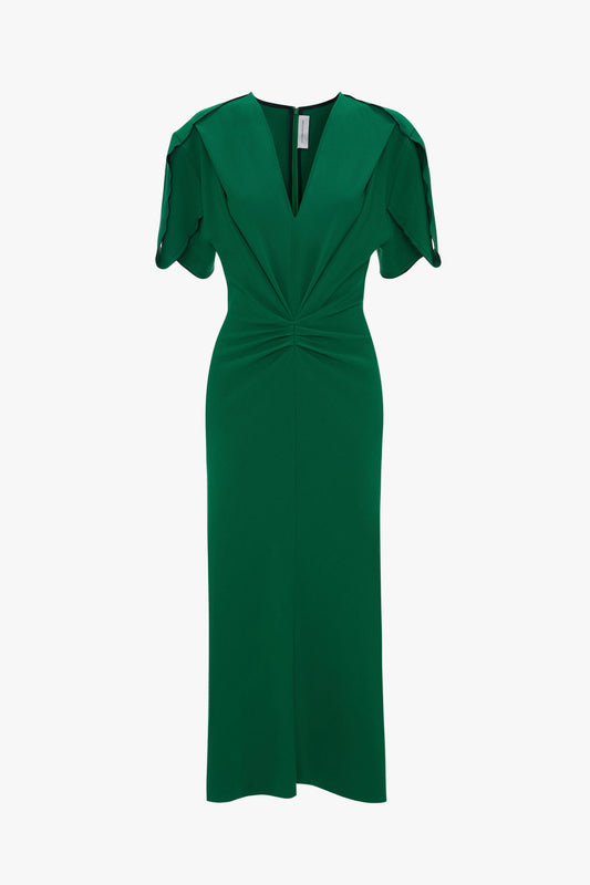 A green knee-length Victoria Beckham Gathered V-Neck Midi Dress in Emerald with short ruffle sleeves and a twisted fabric detail at the waist, displayed against a white background.