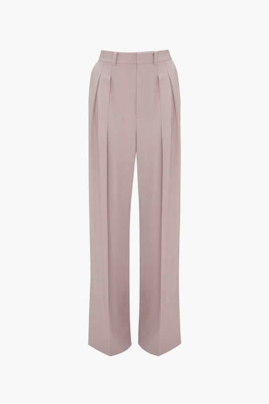 A pair of Double Pleat Trouser In Rose Quartz by Victoria Beckham is displayed against a white background, showcasing a directional silhouette.