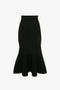 A VB Body Scallop Trim Flared Skirt In Black by Victoria Beckham with a flared silhouette and intricate stitching details, featuring a chic scallop trim at the hem.