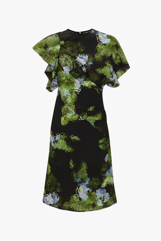 A knee-length black Twist Shoulder Dress In Black Frost by Victoria Beckham with a green and blue abstract floral pattern, featuring ruffled short sleeves, draped pleat details, and an asymmetric hemline.