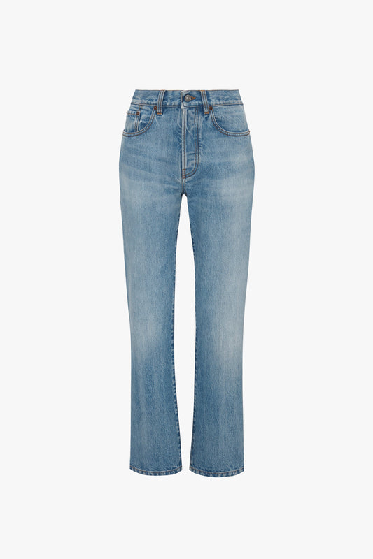 A pair of light blue, mid-rise straight leg Victoria Beckham Victoria Mid-Rise Jean In Light Blue with five pockets and a zip fly with button closure, isolated on a white background.