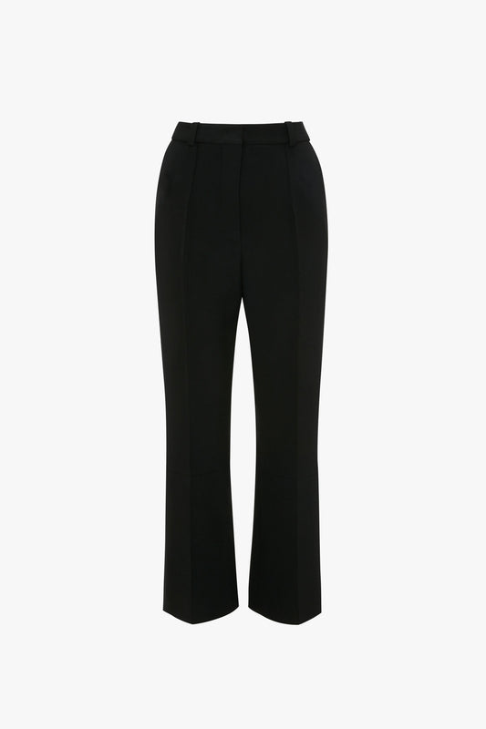 A pair of Cropped Kick Trouser In Black by Victoria Beckham with a straight-leg cut and front crease, shown on a plain white background.