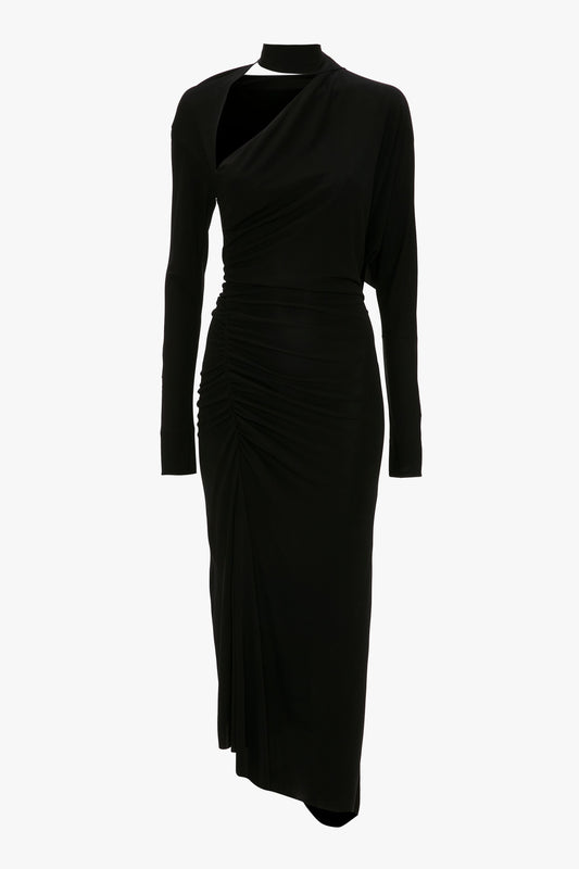 A black long-sleeve gown with an asymmetric cut-out neckline and ruched side detailing, displayed on a mannequin against a white background. This is the Victoria Beckham Slash-Neck Ruched Midi Dress In Black.